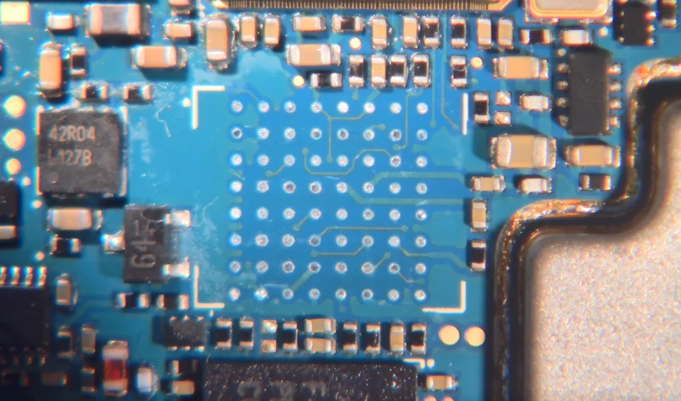 Exposed BGA solder pads on the APX4000 circuit board after flash-chip removal.
