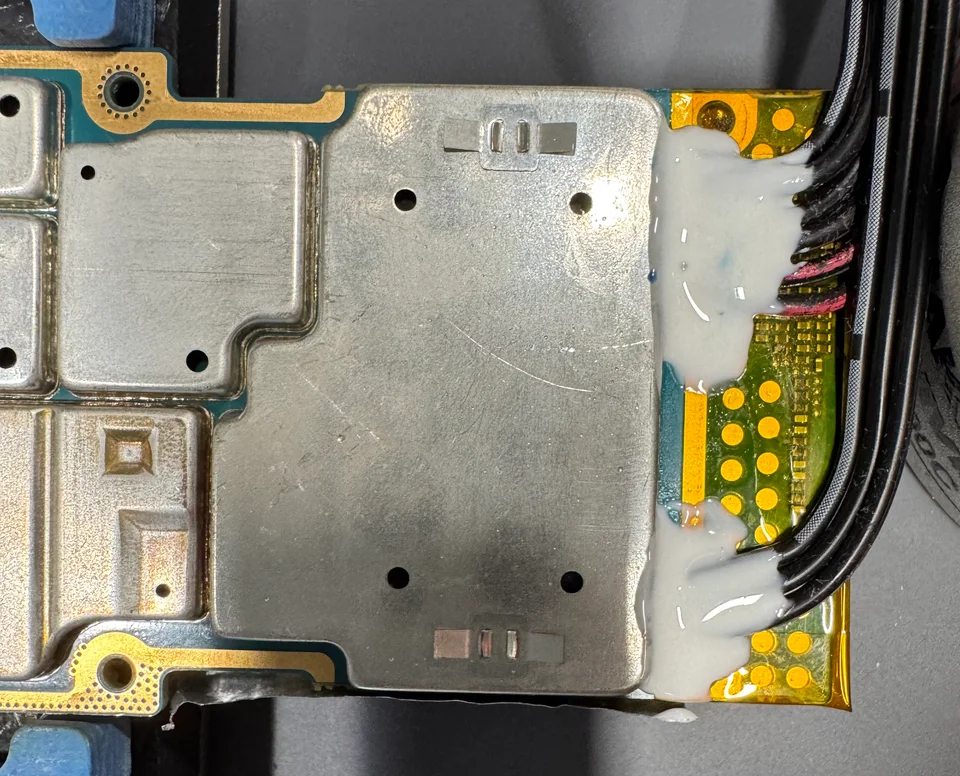 External JTAG wires installed and secured at the edge of a Motorola APX4000 circuit board.